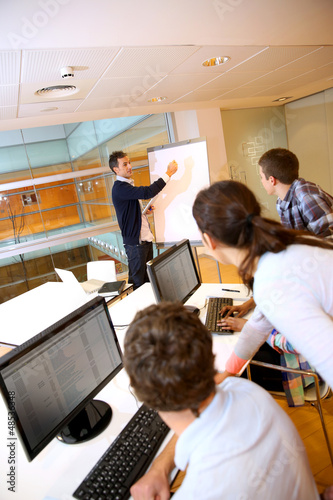 Photo: Teacher in lab doing presentation on whiteboard Teacher in lab doing presentation on whiteboard