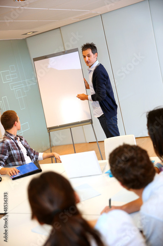Photo: College teacher in class with group of students College teacher in class with group of students