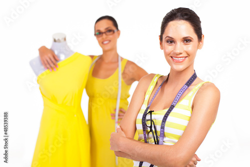Photo: beautiful young female tailors portrait on white beautiful young female tailors portrait on white