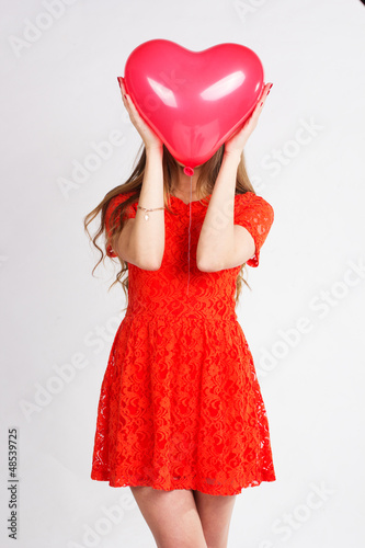 Photo: Valentines day woman holding red heart balloon Valentines day woman holding red heart balloon