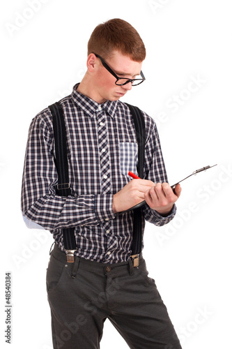 Photo: Young man writing in clip board Young man writing in clip board