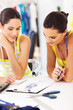 two fashion designers working together on a dress