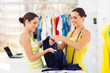 two young female fashion designers choosing fabric