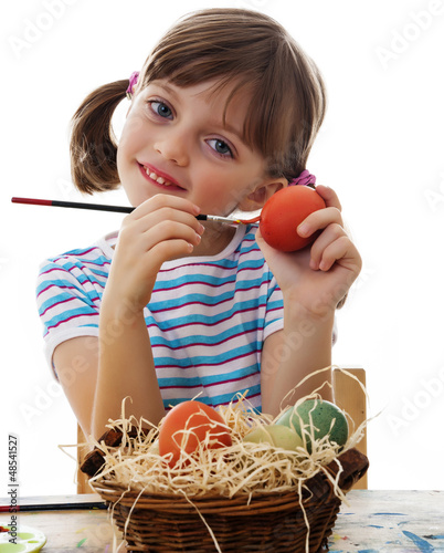 Photo: little girl painting easter eggs little girl painting easter eggs