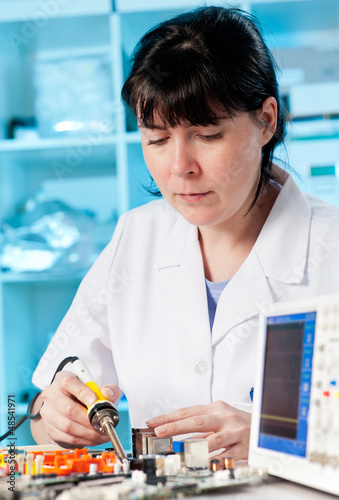 Photo: Tech tests electronic equipment Tech tests electronic equipment