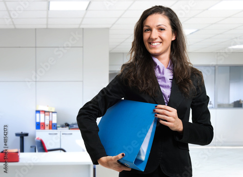 Photo: Businesswoman holding a binder Businesswoman holding a binder