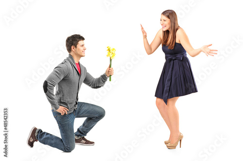 Photo: A male kneeling with flowers and his excited girlfriend A male kneeling with flowers and his excited girlfriend