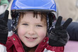 Happy smiling girl 8 years old in blue helmet on a skating-rink