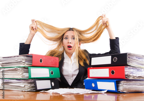 Photo: Busy woman with stacks of paper Busy woman with stacks of paper