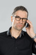 man is skeptical on the phone