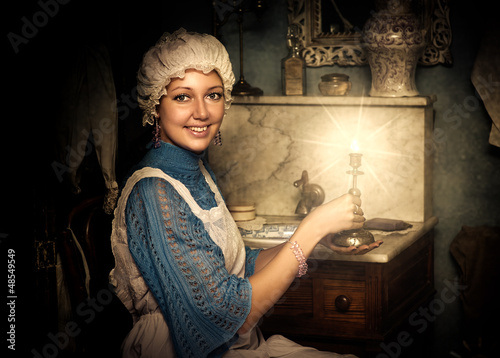 Photo: woman in old cap with candlestick woman in old cap with candlestick