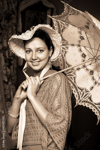 Photo: woman in old hat with a lace umbrella woman in old hat with a lace umbrella