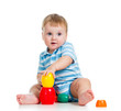 baby boy playing with toys, isolated over white