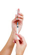Syringe with a medicine in a female hands, isolated on white