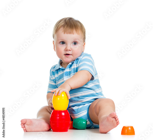Photo: baby boy playing with toys, isolated over white baby boy playing with toys, isolated over white