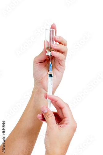 Photo: Syringe with a medicine in a female hands, isolated on white Syringe with a medicine in a female hands, isolated on white
