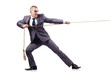 Man in tug of war concept on white