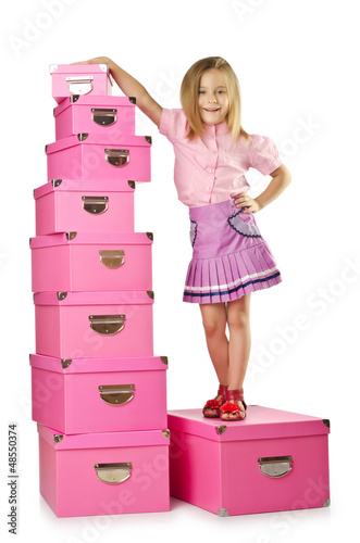 Photo: Little cute girl with lots of boxes Little cute girl with lots of boxes
