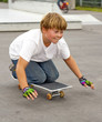 cute boy scooting with his skate board