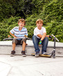 boys are sitting at a box in the skate park