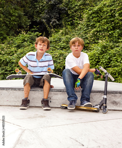 Photo: boys are sitting at a box in the skate park boys are sitting at a box in the skate park