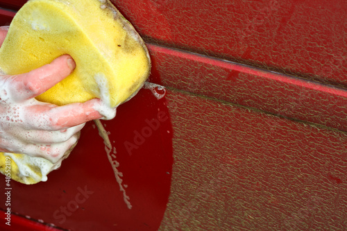 Photo: Cleaning automobile with soapy sponge Cleaning automobile with soapy sponge
