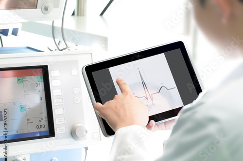 Photo: Doctor at work with a digital tablet Doctor at work with a digital tablet