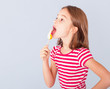 Photo: little girl licking a lollipop little girl licking a lollipop