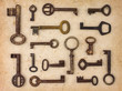 Photo: Different antique keys on a retro paper background Different antique keys on a retro paper background