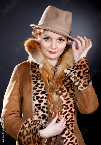 Photo: Attractive redhaired curly woman wearing felt hat Attractive redhaired curly woman wearing felt hat