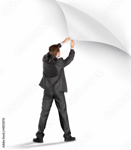Photo: Businessman turning the page Businessman turning the page