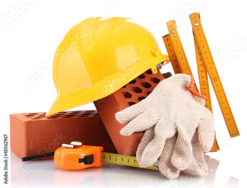 Photo: helmet, roulette, bricks and gloves isolated on white helmet, roulette, bricks and gloves isolated on white