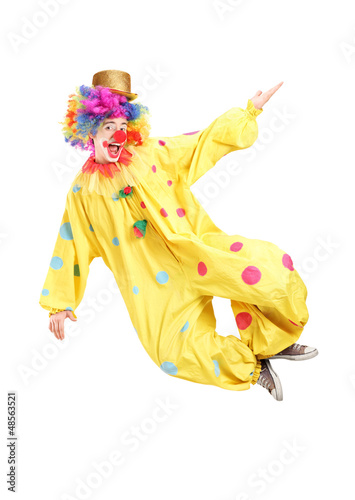 Photo: Full length portrait of a male clown jumping Full length portrait of a male clown jumping