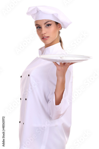 Photo: Portrait of young woman chef with tray isolated on white Portrait of young woman chef with tray isolated on white