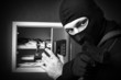 Professional burglar in black mask