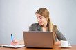 Portrait of a pretty young businesswoman making note