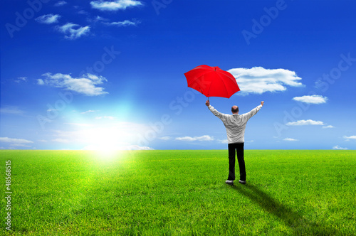 Photo: Happy man with red umbrella jubilates - enjoying life Happy man with red umbrella jubilates - enjoying life