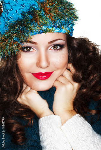 Photo: Happy Woman in Blue Knitted Cap and Knitwear - Warm Jersey Happy Woman in Blue Knitted Cap and Knitwear - Warm Jersey