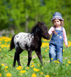 Foto: Child and foal in the field at spring. Child and foal in the field at spring.
