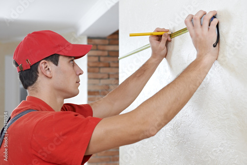 Photo: Handyman with measuring tape Handyman with measuring tape