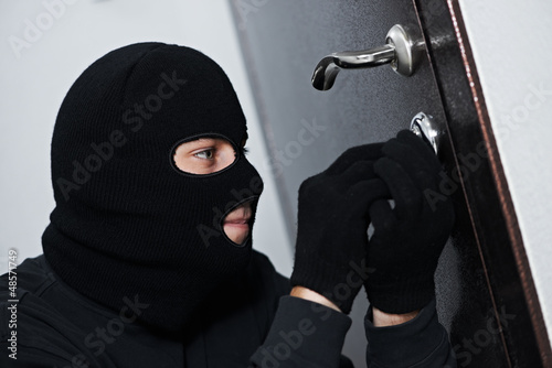 Photo: burglar thief at house breaking burglar thief at house breaking