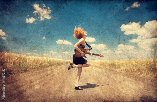 Photo: Red-head girl with guitar. Photo in old image style. Red-head girl with guitar. Photo in old image style.