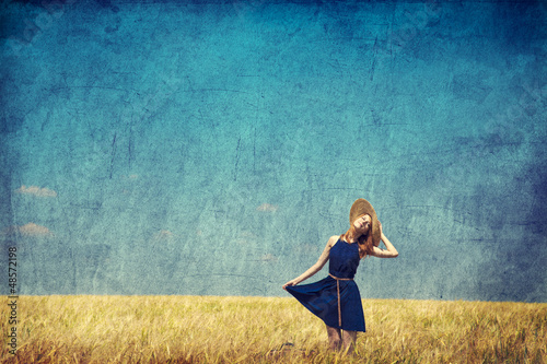 Photo: Lonely girl with suitcase at country. Photo in old color image s Lonely girl with suitcase at country. Photo in old color image s