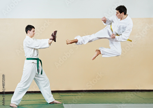 Photo: Two man at taekwondo exercises Two man at taekwondo exercises