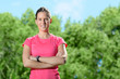 Young sportswoman  standing idly outside in park