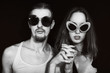 Studio portrait of a young couple wearing sunglasses