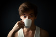 man drinking coffee on dark  background