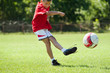 boy kicking football