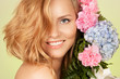 Portrait of attractive woman with flower smiling