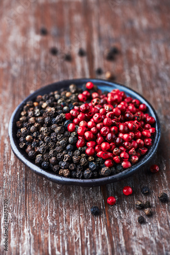 Photo: Black and pink peppercorns on a small plate Black and pink peppercorns on a small plate